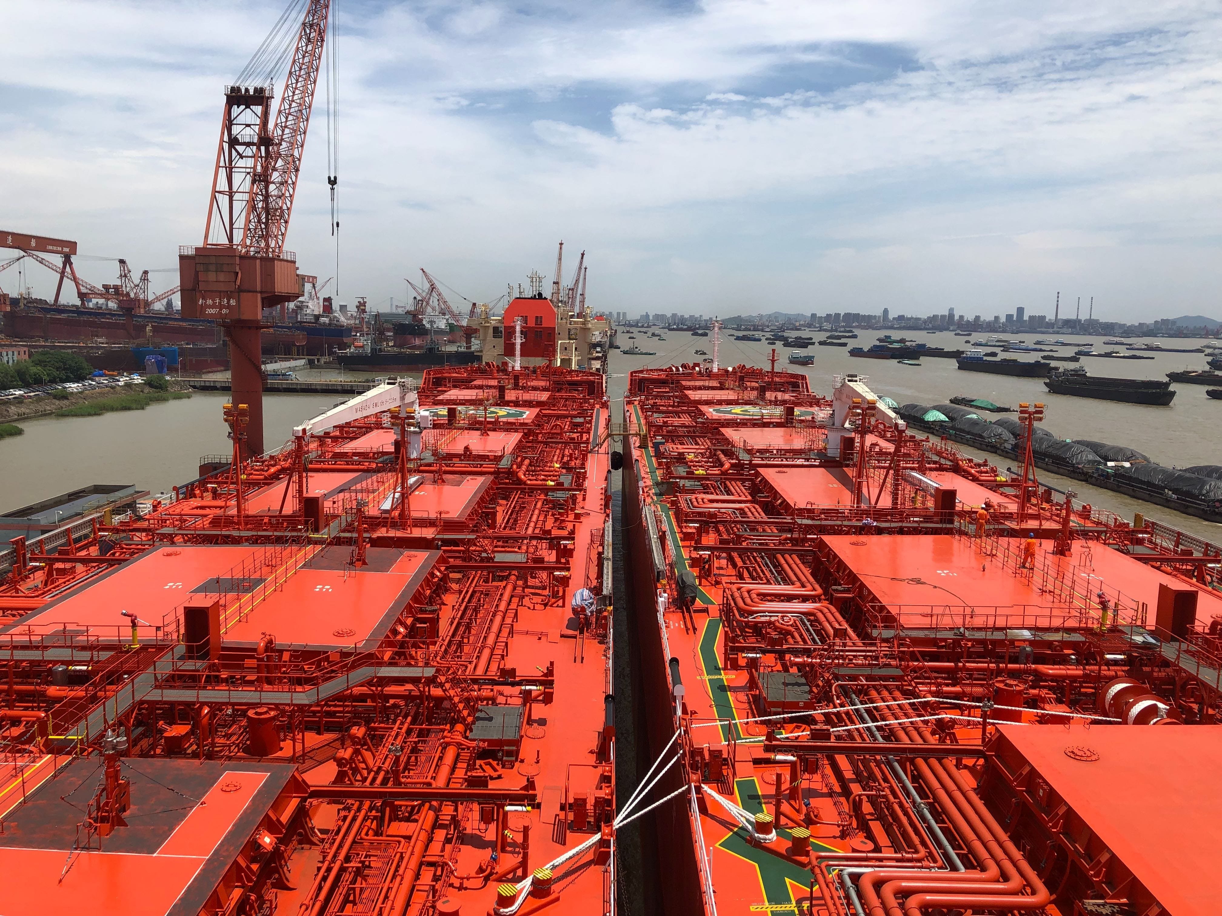 Two large tank ships side by side in a harbour